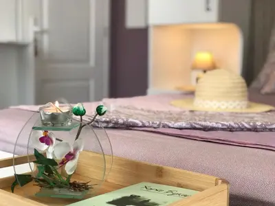 a table with a vase with flowers on it at AMORE Obzor in Obzor