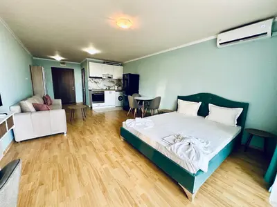 a bedroom with a bed and a living room at Apartments in Panorama Beach Vigo Nessebar in Nesebar