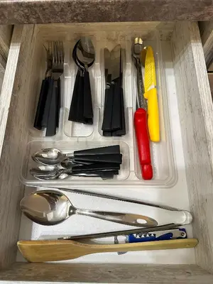 a drawer filled with utensils in a drawer at Апартамент Joy in Varna City