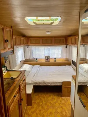 a small bedroom in an rv with a bed at Beachfront Caravans in Chernomorets