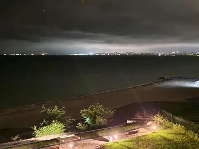 a view of the water at night with a bridge at Sarafovo Resort Deluxe in Burgas City