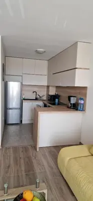 a kitchen with white cabinets and a counter top at Sarafovo Resort Deluxe in Burgas City