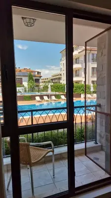 a view of a swimming pool from a window at Sarafovo Resort Deluxe in Burgas City