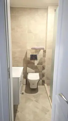 a bathroom with a toilet and a sink at Sarafovo Resort Deluxe in Burgas City