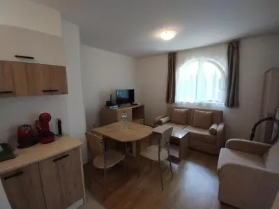 a small living room with a table and a couch at Apartament Messambria Resort - Bastet BS in Sunny Beach