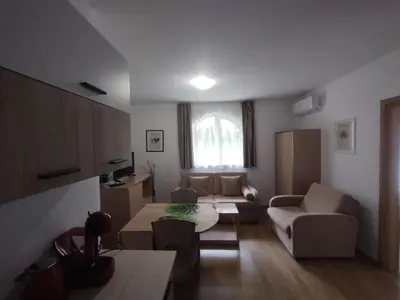 a living room with a couch and a table at Apartament Messambria Resort - Bastet BS in Sunny Beach