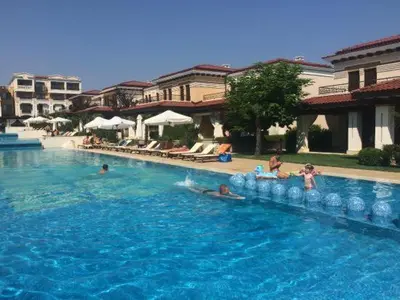 a swimming pool with people in the water at Sea Star Sozopol in Sozopol