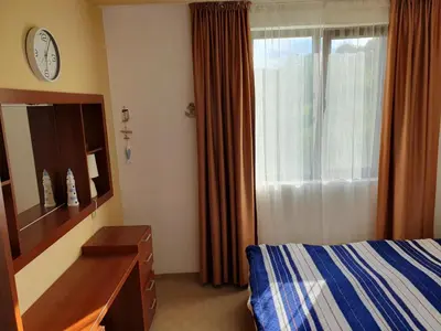 a bedroom with a bed and a dresser and a window at Sea Star Sozopol in Sozopol