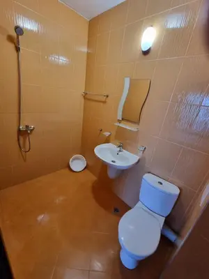 a bathroom with a toilet and a sink at Стаи за гости Мистрал in Primorsko