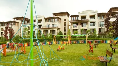 a playground in a park in front of a building at Green Line Villa Sozopol in Sozopol