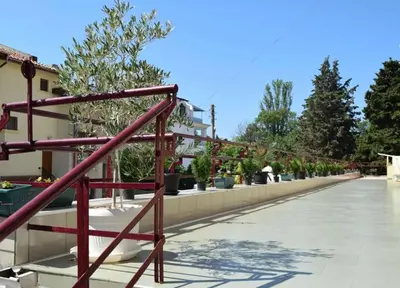 a long walkway with potted plants on it at Sozopol Apartment 3 in Sozopol