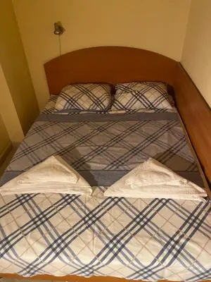a bed with two pillows on top of it at Sozopol Apartment 3 in Sozopol