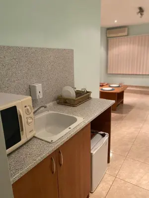 a kitchen with a sink and a microwave on a counter at Sozopol Apartment 3 in Sozopol