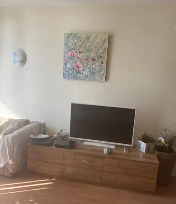 a flat screen tv sitting on top of a wooden dresser at Fort Noks - Marina View in Sveti Vlas