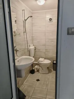 a bathroom with a sink and a toilet at Къща за гости Пиргос in Burgas City