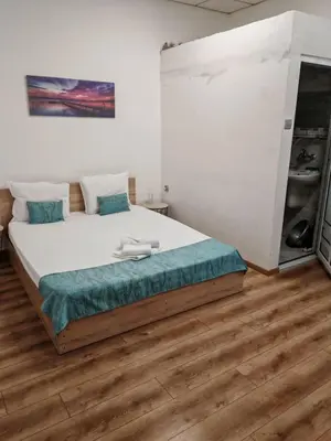 a bedroom with a large bed in a room at Къща за гости Пиргос in Burgas City