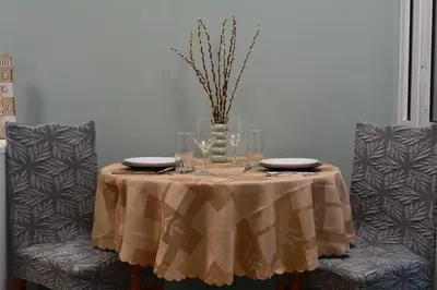 a table with glasses and a vase on it at City Center Apartment in Burgas City