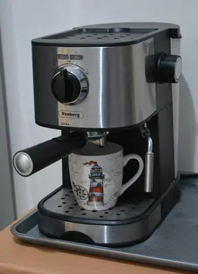 a coffee maker with a cup on a shelf at City Center Apartment with a Backyard in Burgas City