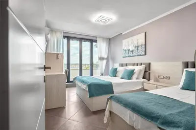 a hotel room with two beds and a window at 3BD Beach Paradise with a Stunning View with Parking by Flat Mаnаger in Nesebar