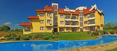 a large building with a pool in front of it at Апартамент в Oasis Beach Kamchia -THE FAVOURITE BLUE in Bliznatsi