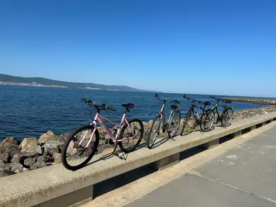 four bikes parked on a bridge near the water at Sea View Private Studio Paradiso B 509 in Nesebar