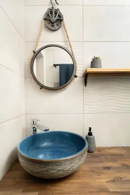 a bathroom with a large blue tub and a mirror at Boutique Blue Apartment in Sveti Vlas