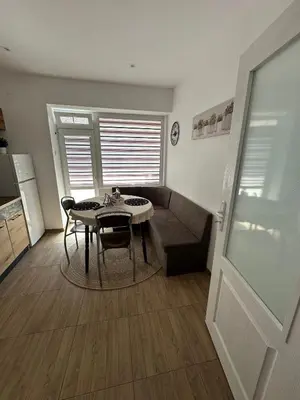 a living room with a table and a couch at Apartment ADELINA in Tsarevo