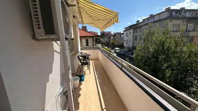 a balcony with a yellow awning on a building at Apartment ADELINA in Tsarevo