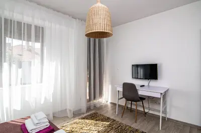 a room with a desk and a computer and a window at Greek quarter flat two BR next to Sea Garden in Varna City