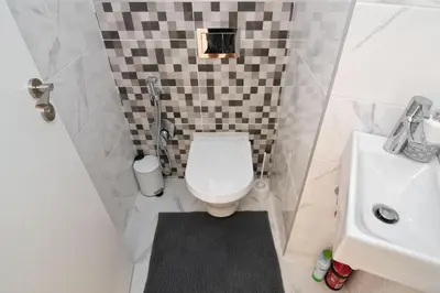 a small bathroom with a toilet and a sink at Greek quarter flat two BR next to Sea Garden in Varna City