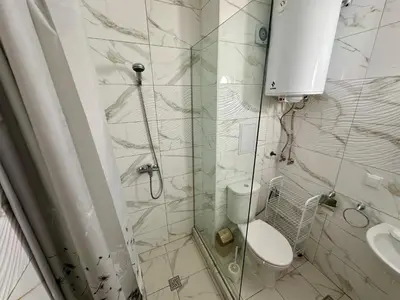 a bathroom with a shower with a toilet and a sink at Chateau Aheloy 2 - Menada Apartments in Aheloy