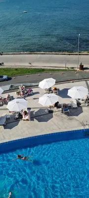 an overhead view of a swimming pool with white umbrellas at Sea View Private Studio B 511 in Nesebar
