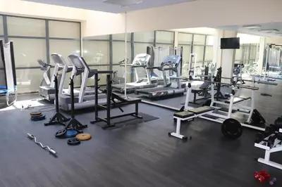 a gym with several treadmills and machines in it at Sea View Private Studio B 511 in Nesebar