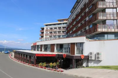 a large building with a pizza restaurant on the side of a street at Sea View Private Studio B 511 in Nesebar