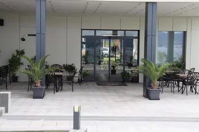 an empty patio with tables and chairs and plants at Sea View Private Studio B 511 in Nesebar