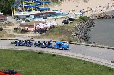 a group of people riding on a train at a beach at Sea View Private Studio B 511 in Nesebar
