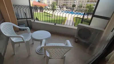 a balcony with a table and chairs and a window at Royal Sun Complex in Sunny Beach