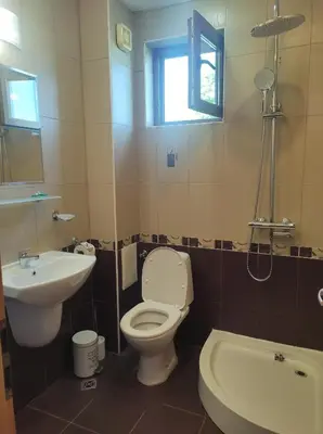 a bathroom with a toilet and a sink at Апартамент в Oasis beach Kamchia - Стъпки в пясъка in Kamchia