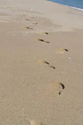 a pair of footprints in the sand on a beach at Апартамент в Oasis beach Kamchia - Стъпки в пясъка in Kamchia