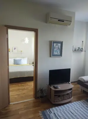 a room with a bedroom with a bed and a mirror at Апартамент в Oasis beach Kamchia - Стъпки в пясъка in Kamchia