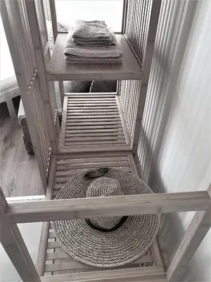 a set of three wooden shelves with a basket at Elisa Studio in Byala