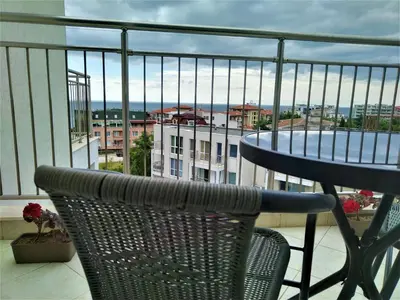 a balcony with a table and chairs and a view of a city at Elisa Studio in Byala