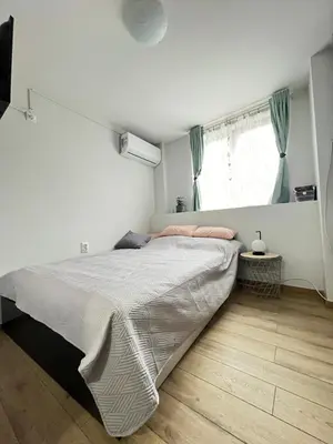 a bedroom with a large bed and a window at Мореплавателите / The seafarers in Sozopol