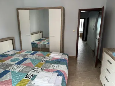a bedroom with two beds and a mirror at Sea View 2BR Apartment Sozopol in Sozopol