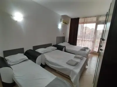 a hospital room with three beds and a window at Сънсет Бийч 3 in Sunny Beach