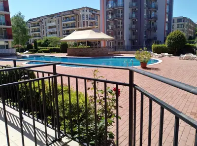 a swimming pool with a gazebo and buildings at Сънсет Бийч 3 in Sunny Beach