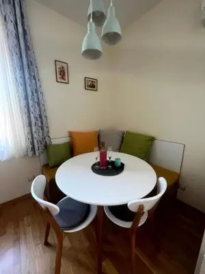 a white table and chairs in a room at Sea Vibes - Modern Apartment Near the Beach & City Center, Burgas in Burgas City