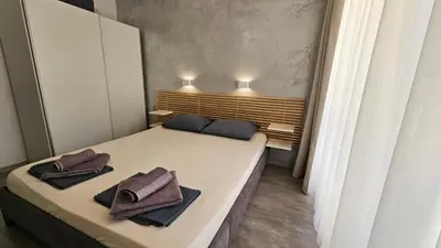 a small room with a bed with towels on it at Horizont Apartment Sozopol in Sozopol