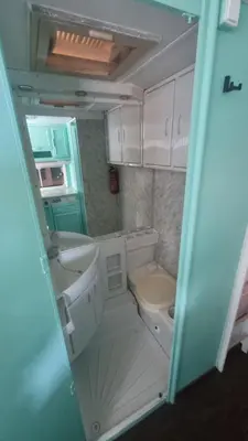 a small bathroom with a sink and a toilet at Каравана Тиана in Sozopol