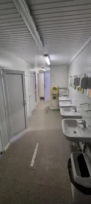 a bathroom with a row of sinks and toilets at Каравана Тиана in Sozopol